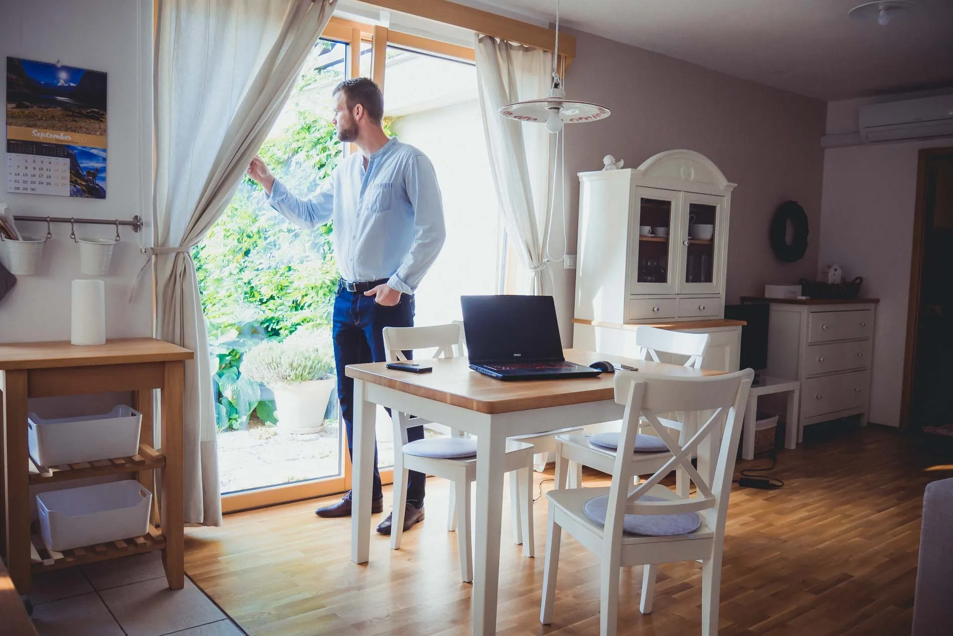 Primoz Lazar working at a laptop by the window